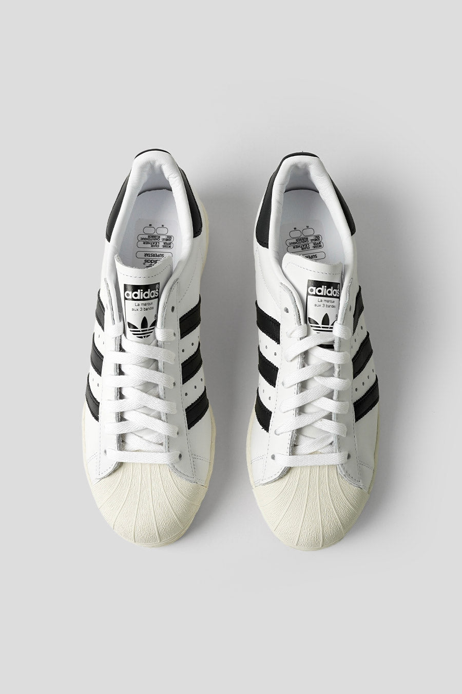 ADIDAS - CLOUD WHITE, CORE BLACK AND OFF WHITE SUPERSTAR 82 SNEAKERS LE LABO STORE ADIDAS - CLOUD WHITE, CORE BLACK AND OFF WHITE SUPERSTAR 82 SNEAKERS LE LABO STORE