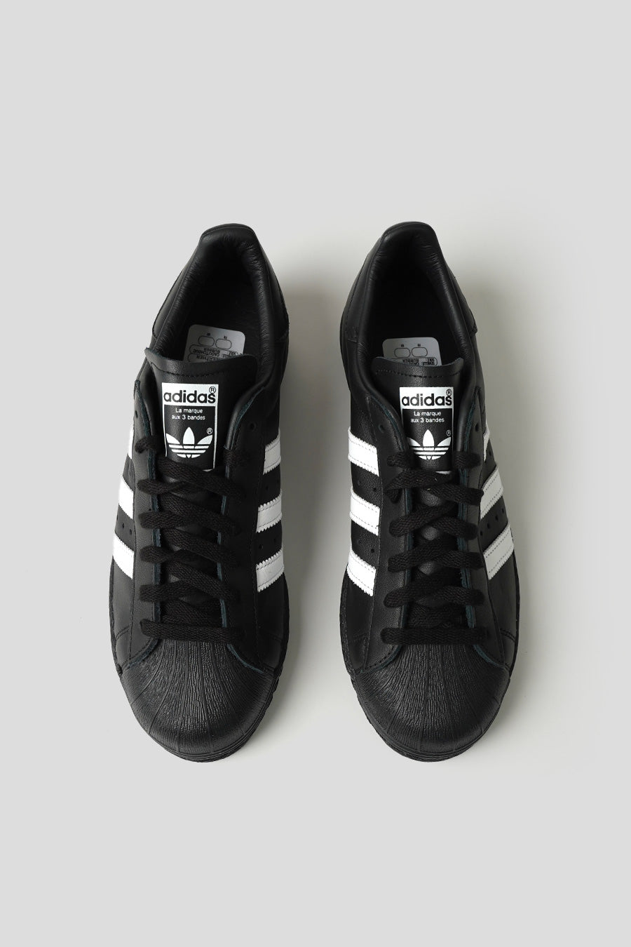 ADIDAS - CORE BLACK AND CLOUD WHITE SUPERSTAR 82 SNEAKERS LE LABO STORE ADIDAS - CORE BLACK AND CLOUD WHITE SUPERSTAR 82 SNEAKERS LE LABO STORE